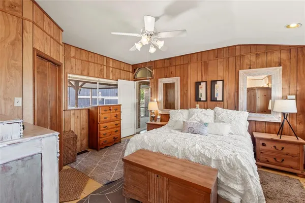 a bedroom with a large bed and a chandelier
