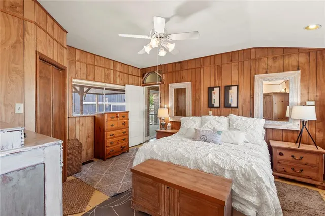 a bedroom with a large bed and a chandelier