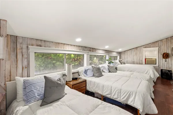 a bedroom with a large bed and a large window