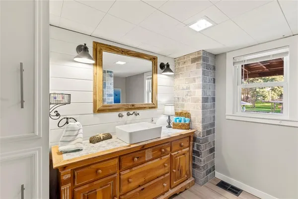 a bathroom with a granite countertop sink mirror and double