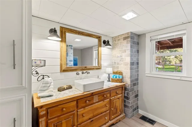 a bathroom with a granite countertop sink mirror and double