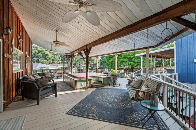 a view of a patio with table and chairs potted plants with wooden floor and fence