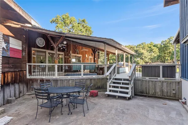 a view of a chairs and table in the balcony