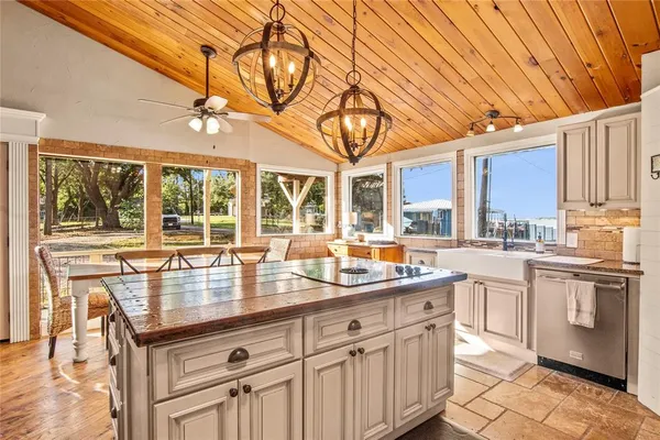 a kitchen with stainless steel appliances granite countertop a sink and cabinets