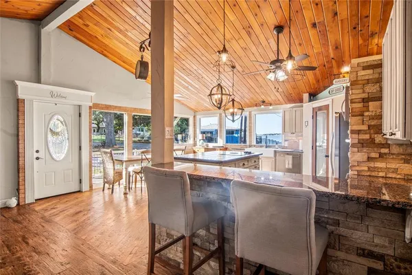 a dining room with furniture and large windows