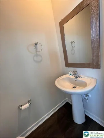 a bathroom with a sink a toilet and mirror