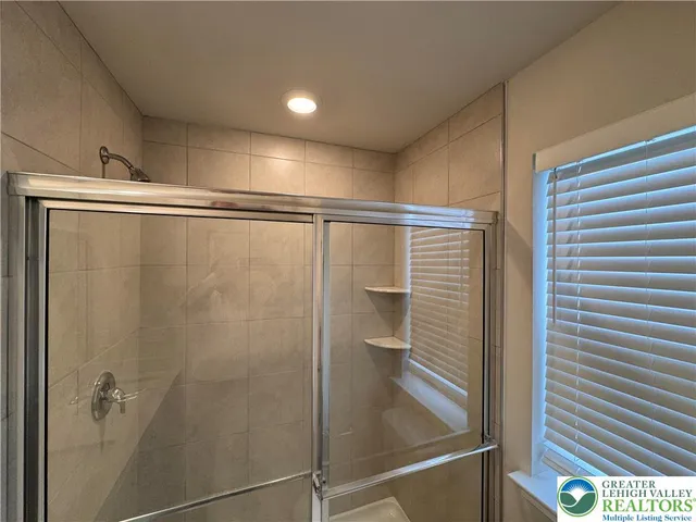 a bathroom with a shower and a sink