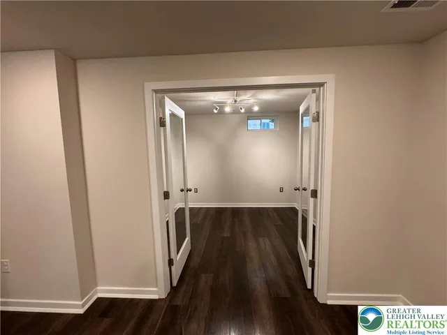 a view of a hallway with wooden floor