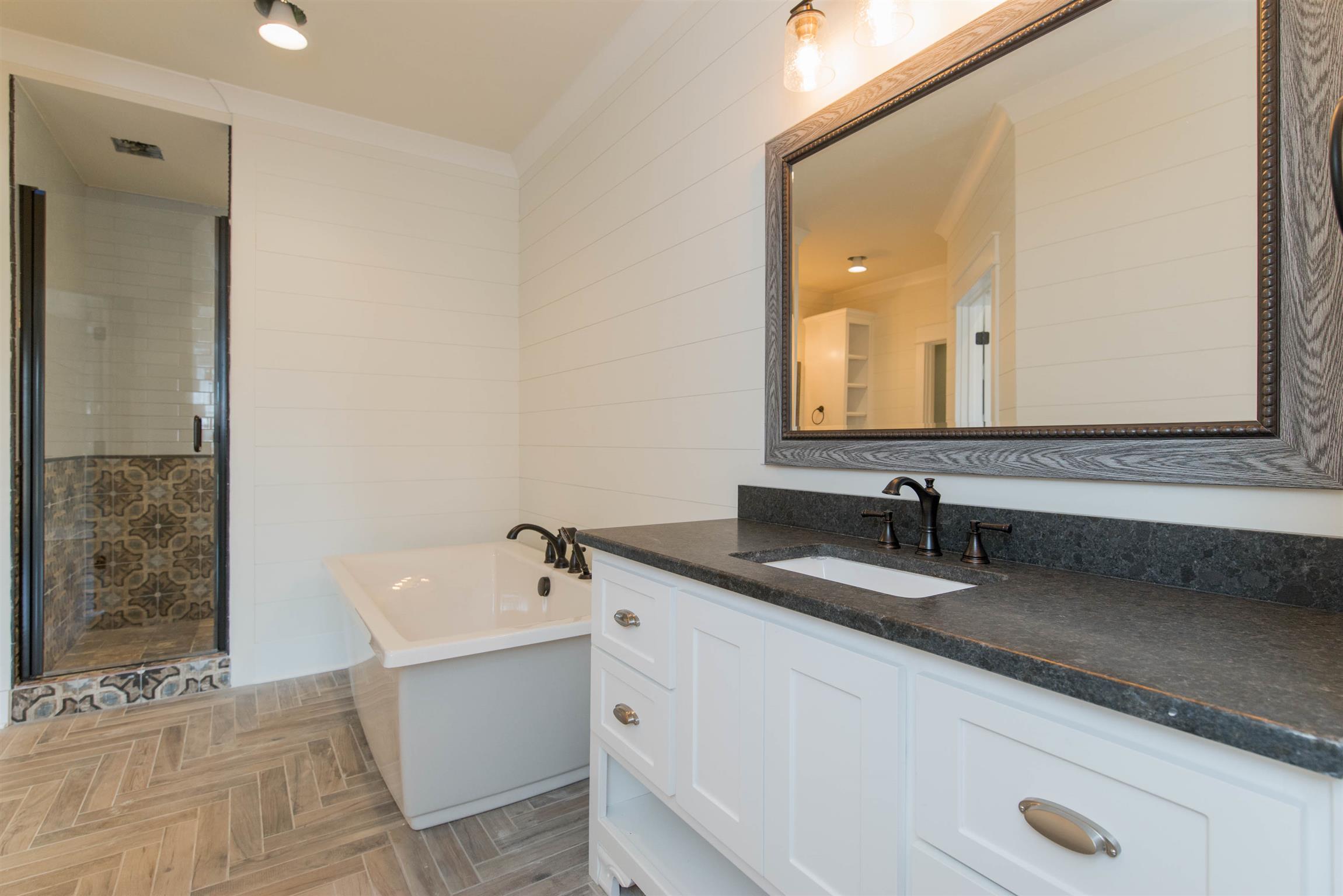 6988 Williams Road Christiana, TN 37037 - Photo 16 of 30 The master bathroom has so much to offer with this seperated double vanity with custom built in storage tower. Free standing tub with handheld sprayer. Seperated toilet room. Framed mirrors. Custom walk in shower with hand held sprayer.