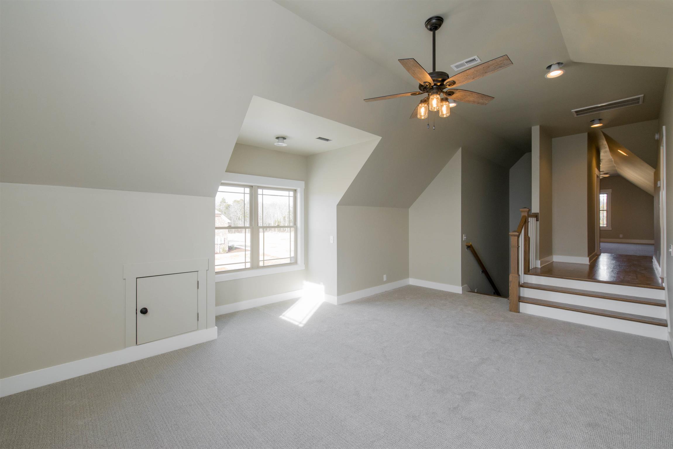 6988 Williams Road Christiana, TN 37037 - Photo 21 of 30 1 of 2 bonus rooms. This first bonus room features a shiplap accent wall with lots of natural light. This room also has access to storage in knee walls for extra storage.