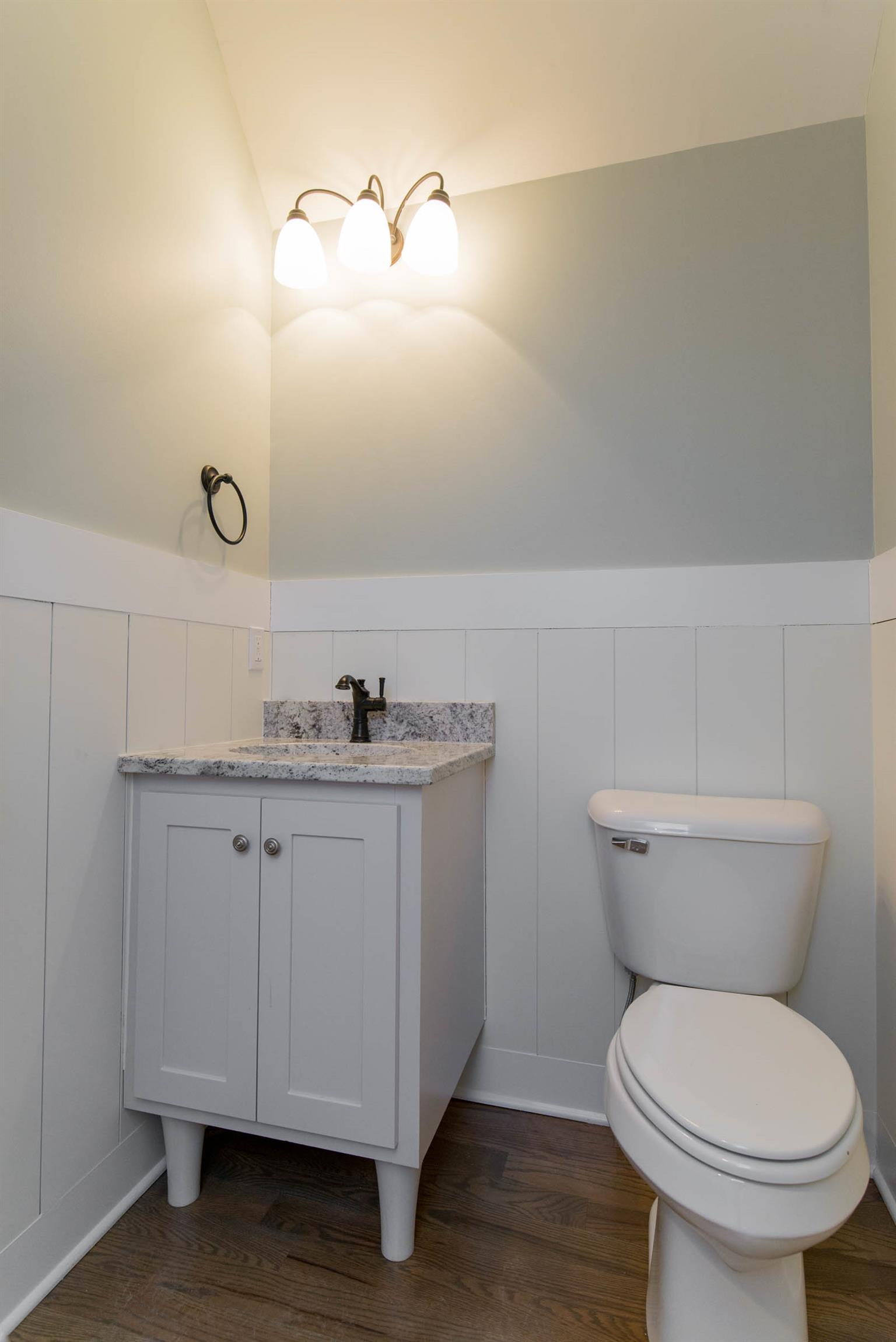 6988 Williams Road Christiana, TN 37037 - Photo 23 of 30 Half bath upstairs between 2 bonus rooms. This half bath features shiplap walls, custom vanity with granite countertop. Hardwood floor.