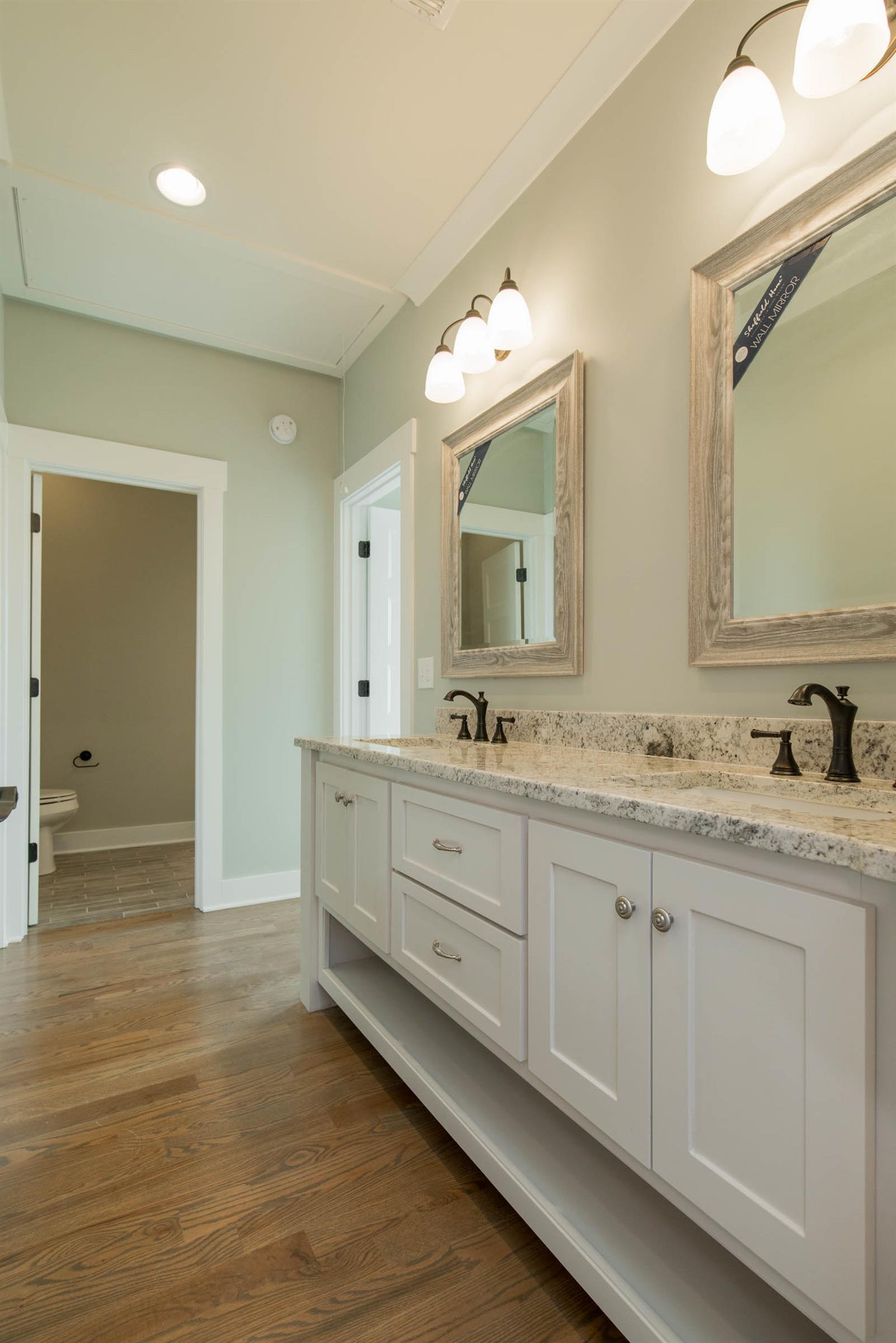 6988 Williams Road Christiana, TN 37037 - Photo 25 of 30 This double vanity bathroom upstairs is shared by jack and jill style bedrooms. Seperate toilet and shower room. Hardwood and tile flooring. This bathroom also has acess to 2 bonus rooms.