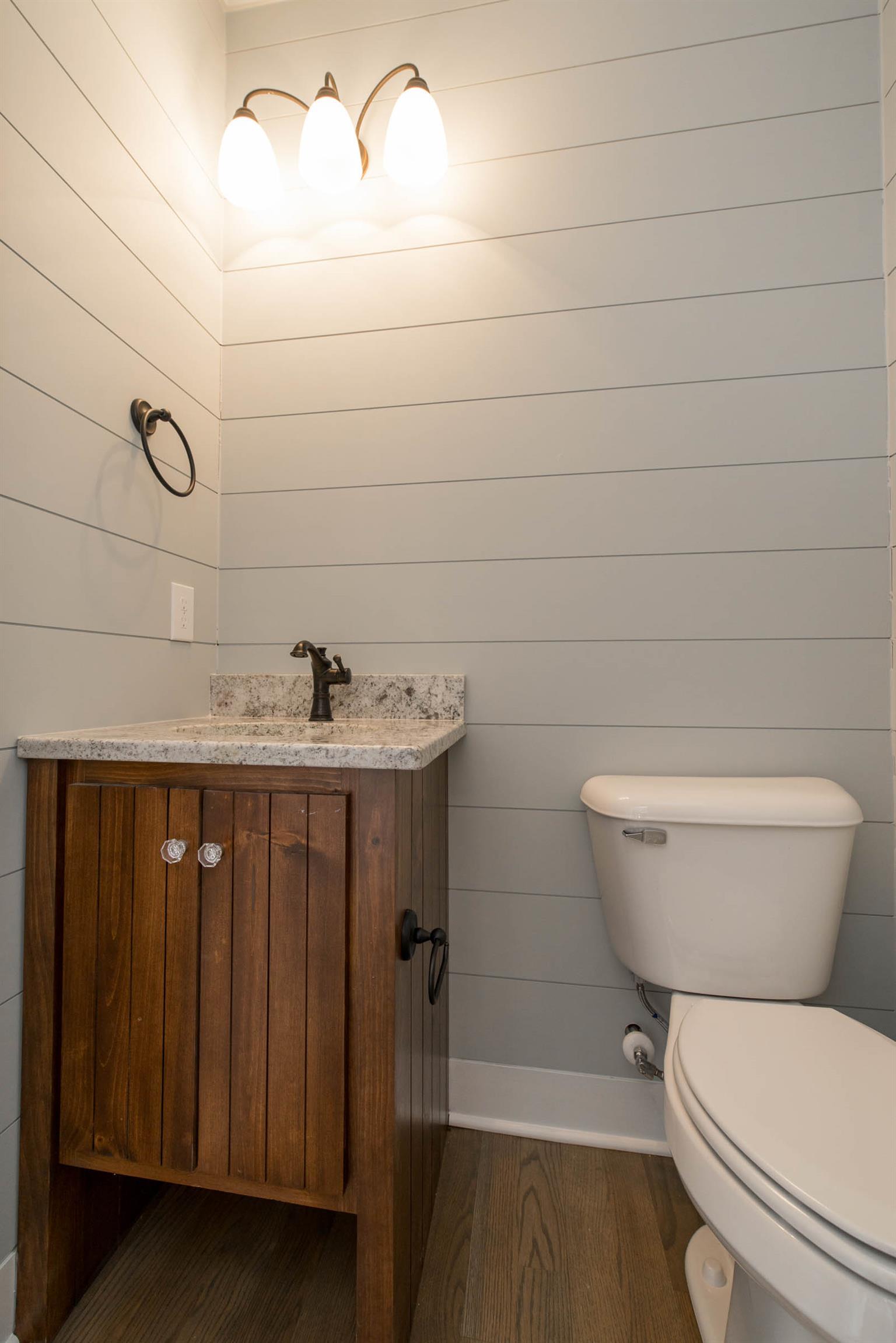 6988 Williams Road Christiana, TN 37037 - Photo 7 of 30 Half bath downstairs featuring shiplap and granite countertop.