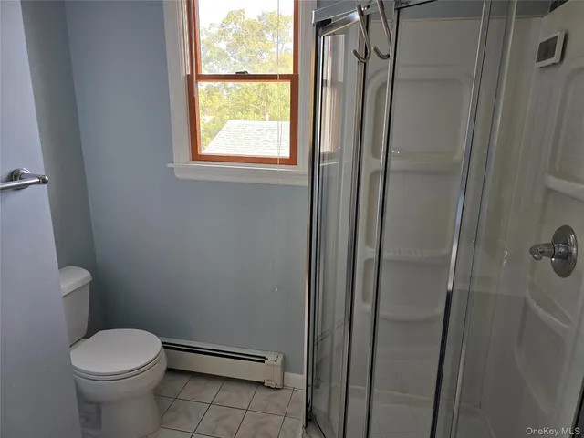 a view of a hallway with wooden floor and a potted plant