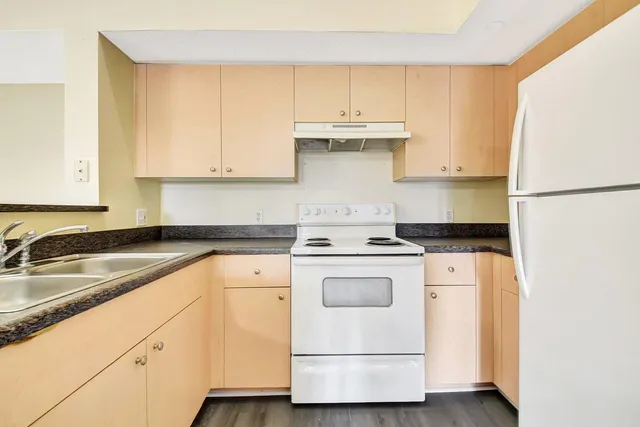 a kitchen with a white cabinets and white appliances