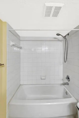 a bedroom with a bed and a night stand