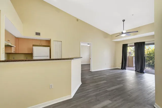 a view of a kitchen with a dishwasher cabinets and wooden floor