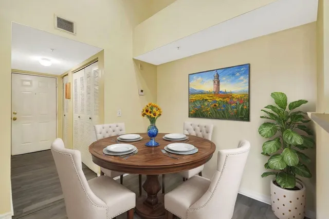 a view of a dining room with furniture and wooden floor