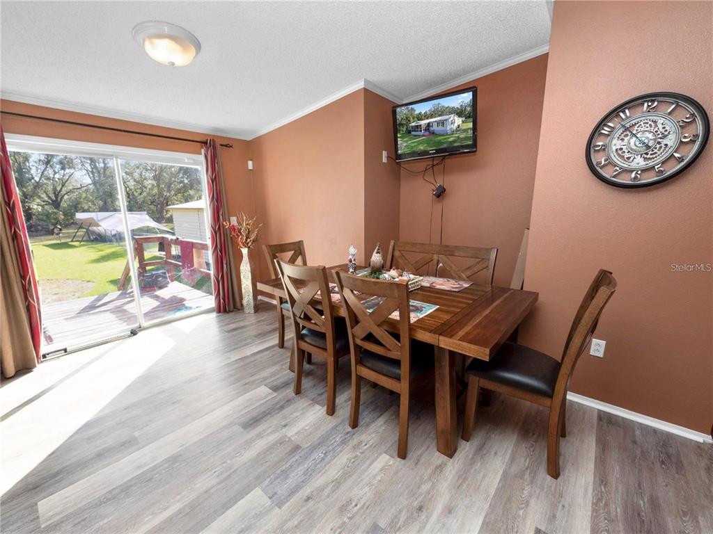 3201 Tenoroc Mine Road Lakeland, FL 33805 - Photo 15 of 48 a view of a dining room with furniture window and wooden floor
