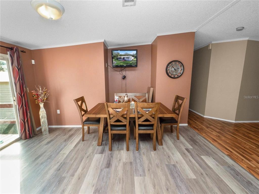 3201 Tenoroc Mine Road Lakeland, FL 33805 - Photo 16 of 48 a view of a dining room with furniture and wooden floor