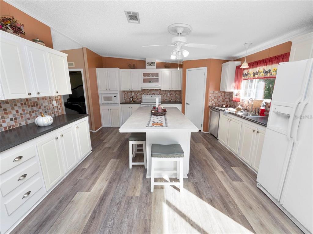 3201 Tenoroc Mine Road Lakeland, FL 33805 - Photo 17 of 48 a kitchen with granite countertop a sink appliances cabinets and furniture