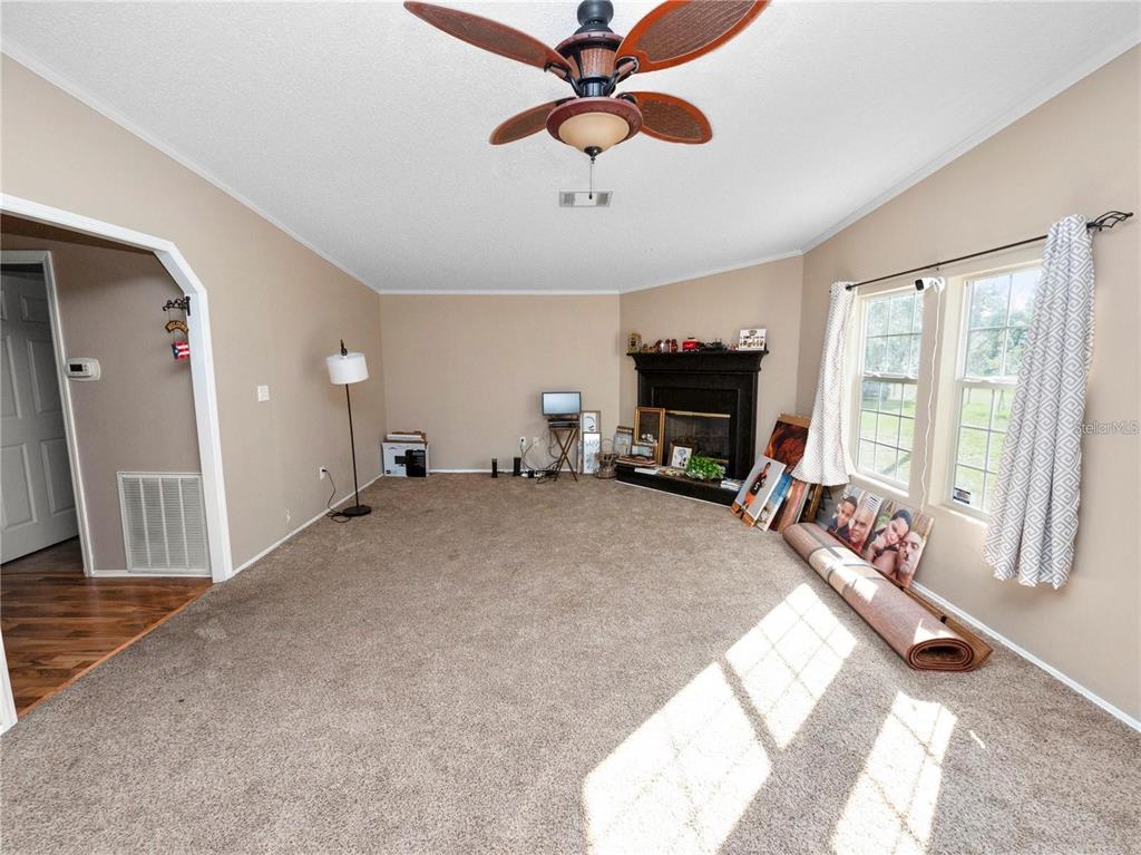 3201 Tenoroc Mine Road Lakeland, FL 33805 - Photo 23 of 48 a living room with furniture and a fireplace