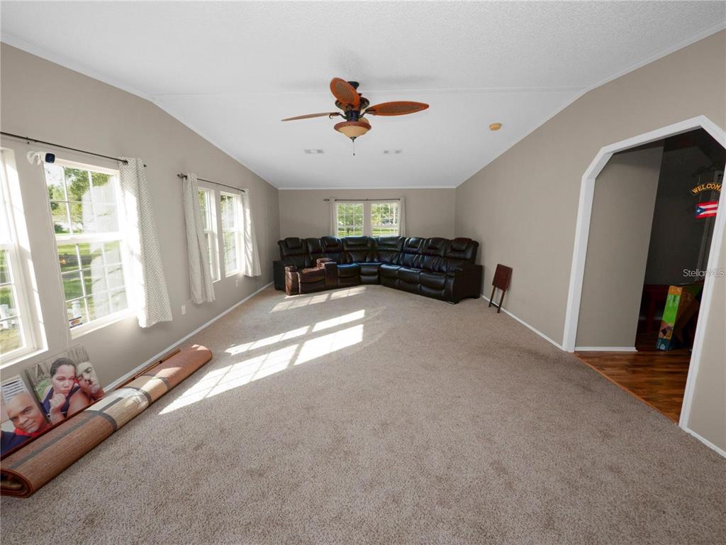 3201 Tenoroc Mine Road Lakeland, FL 33805 - Photo 24 of 48 a view of a livingroom with furniture hardwood floor and a ceiling fan