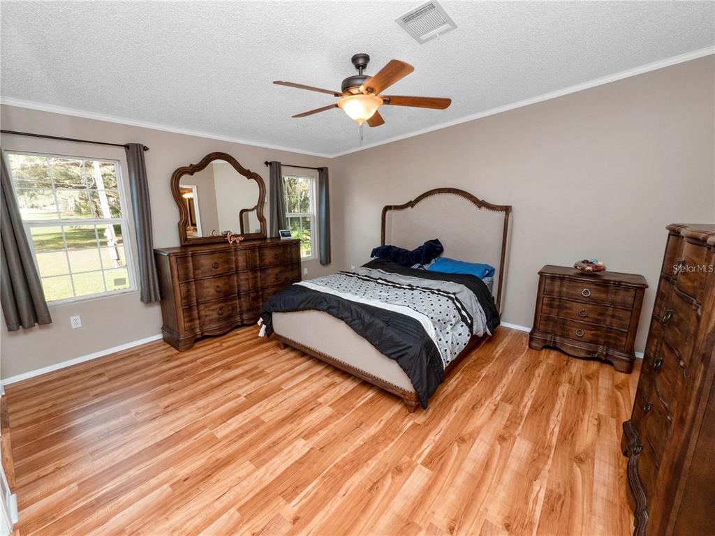 3201 Tenoroc Mine Road Lakeland, FL 33805 - Photo 25 of 48 a bedroom with a bed and wooden floor