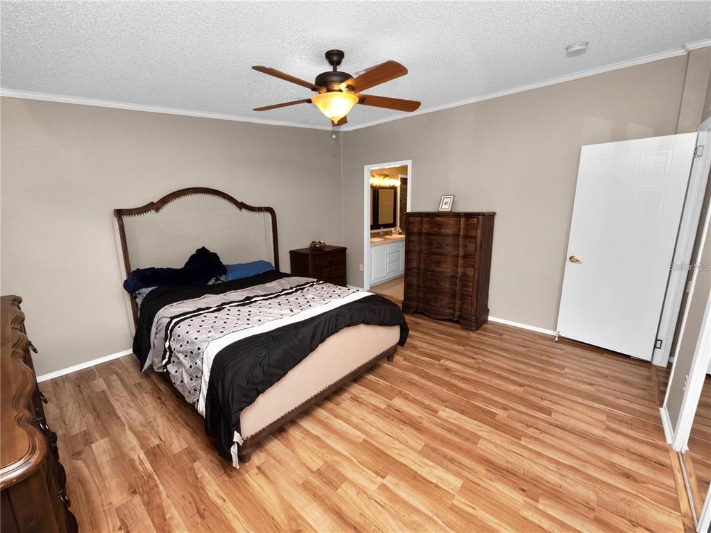 3201 Tenoroc Mine Road Lakeland, FL 33805 - Photo 26 of 48 a bedroom with a bed and wooden floor