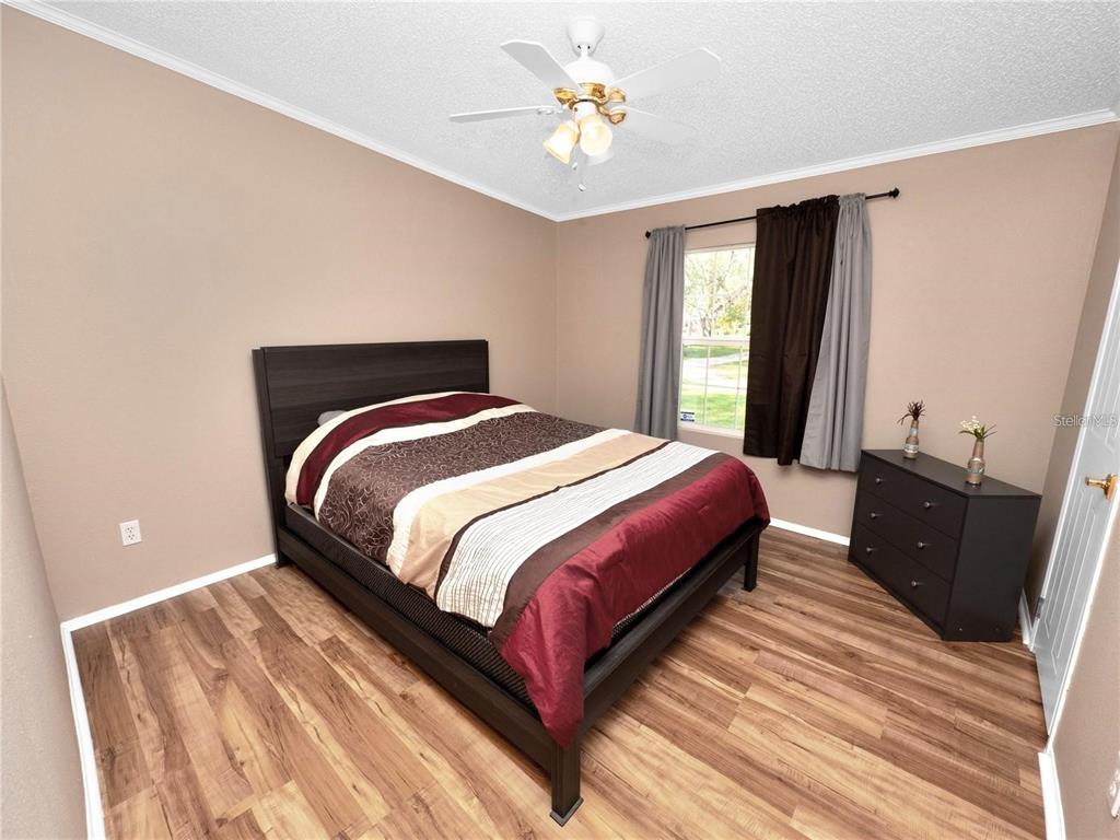 3201 Tenoroc Mine Road Lakeland, FL 33805 - Photo 30 of 48 a bedroom with a bed and a chandelier