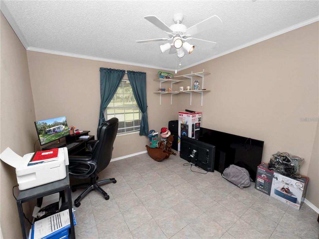 3201 Tenoroc Mine Road Lakeland, FL 33805 - Photo 31 of 48 a bed room with a bed and a chandelier