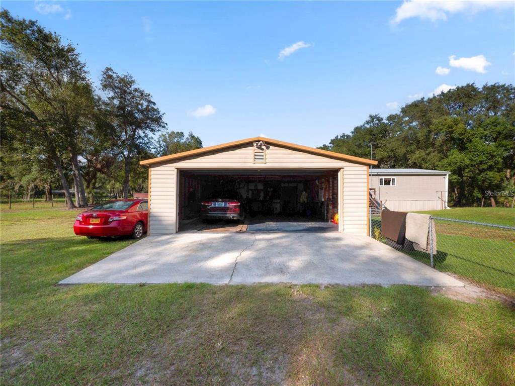 3201 Tenoroc Mine Road Lakeland, FL 33805 - Photo 40 of 48 a front view of a house with a garden and parking