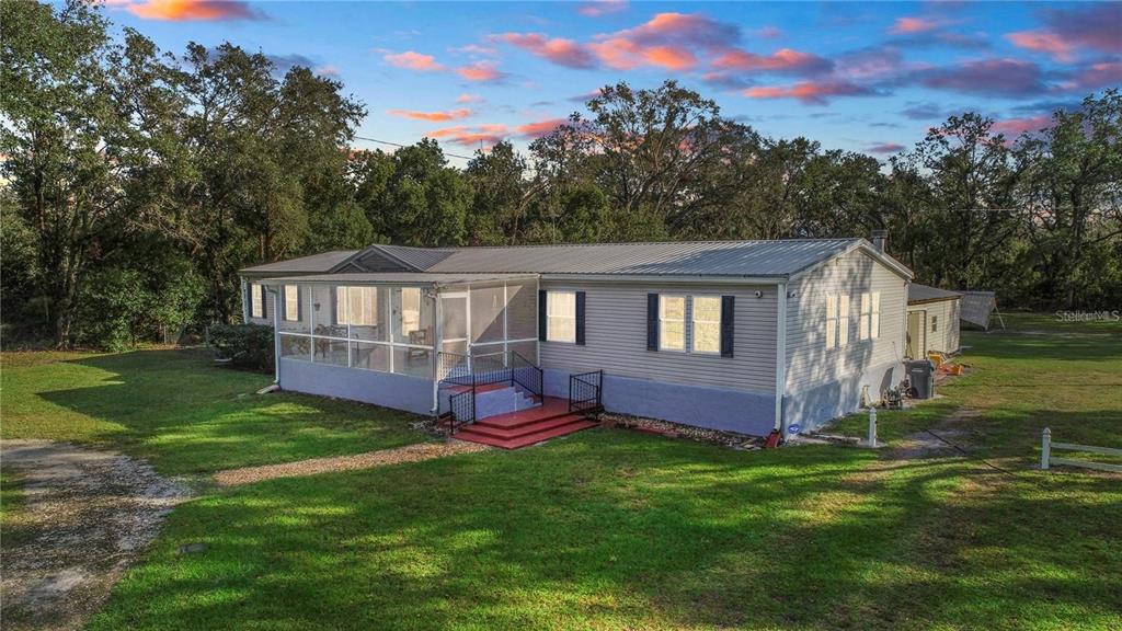 3201 Tenoroc Mine Road Lakeland, FL 33805 - Photo 46 of 48 a aerial view of a house with a yard table and chairs