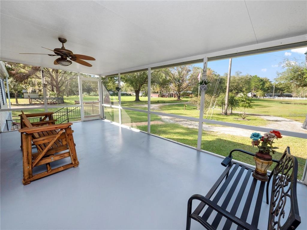 3201 Tenoroc Mine Road Lakeland, FL 33805 - Photo 8 of 48 a view of a living room and a floor to ceiling window and a swimming pool