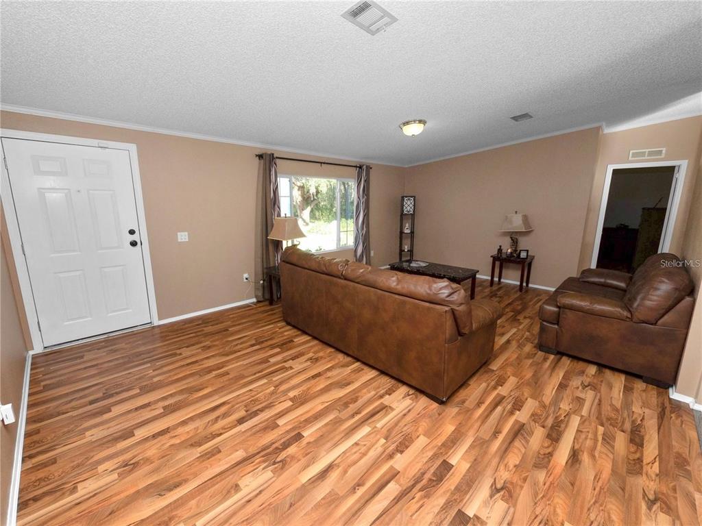 3201 Tenoroc Mine Road Lakeland, FL 33805 - Photo 10 of 48 a living room with furniture and a flat screen tv