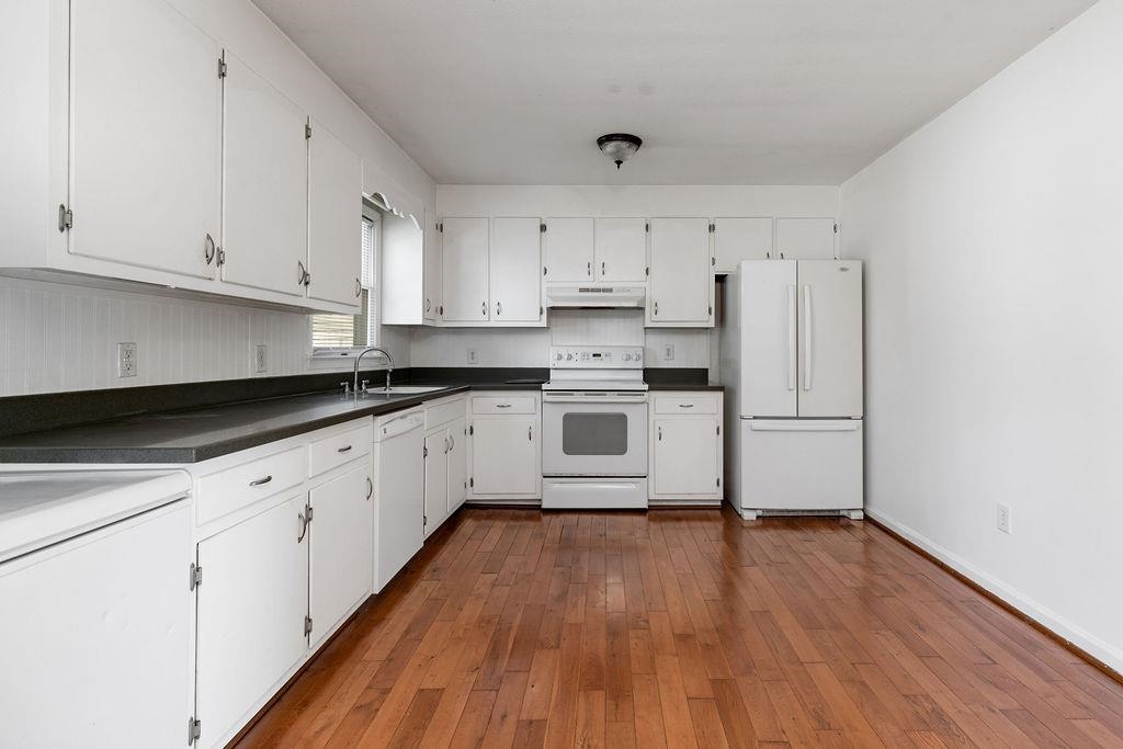 66 Hayrick Road Waynesboro, VA 22980 - Photo 11 of 26 a kitchen with granite countertop white cabinets and white appliances