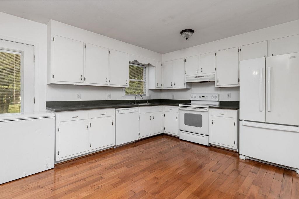 66 Hayrick Road Waynesboro, VA 22980 - Photo 12 of 26 a white kitchen with granite countertop white cabinets and white appliances