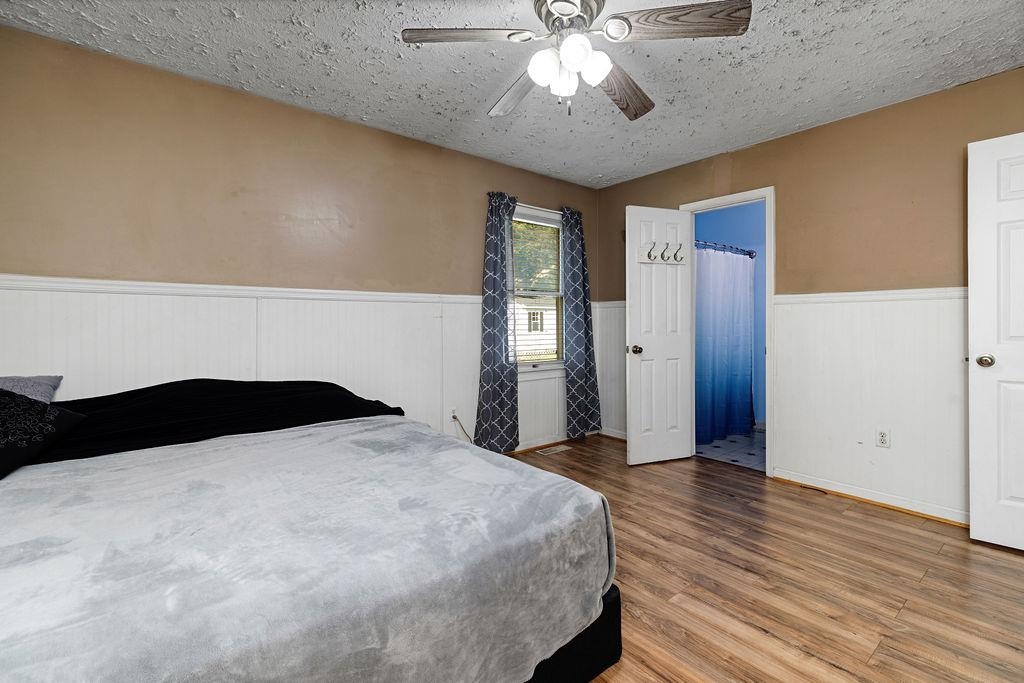 66 Hayrick Road Waynesboro, VA 22980 - Photo 19 of 26 a bedroom with a large bed and a chandelier