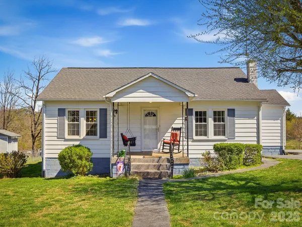 a front view of house with a garden and patio