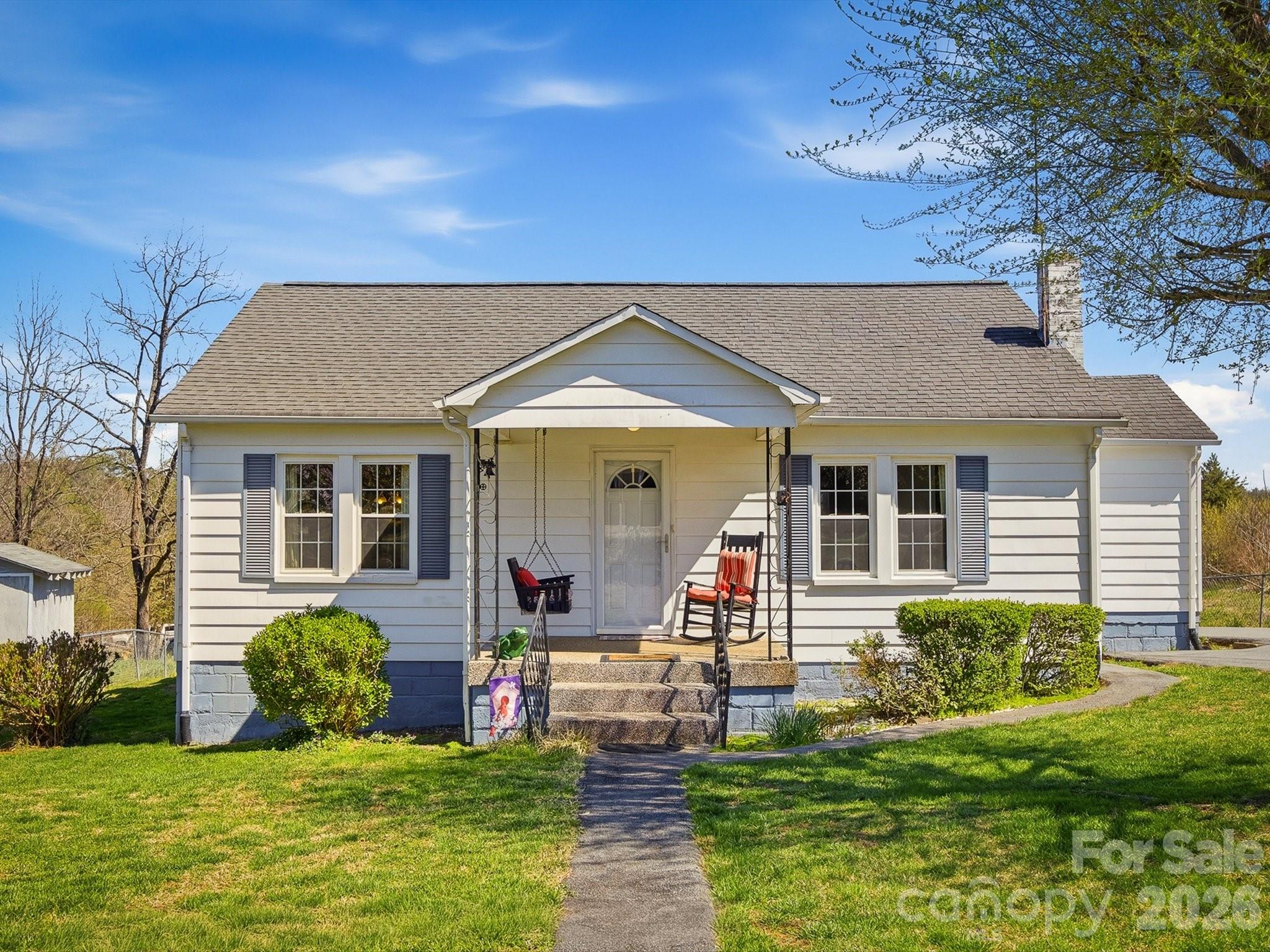 a front view of house with a garden and patio