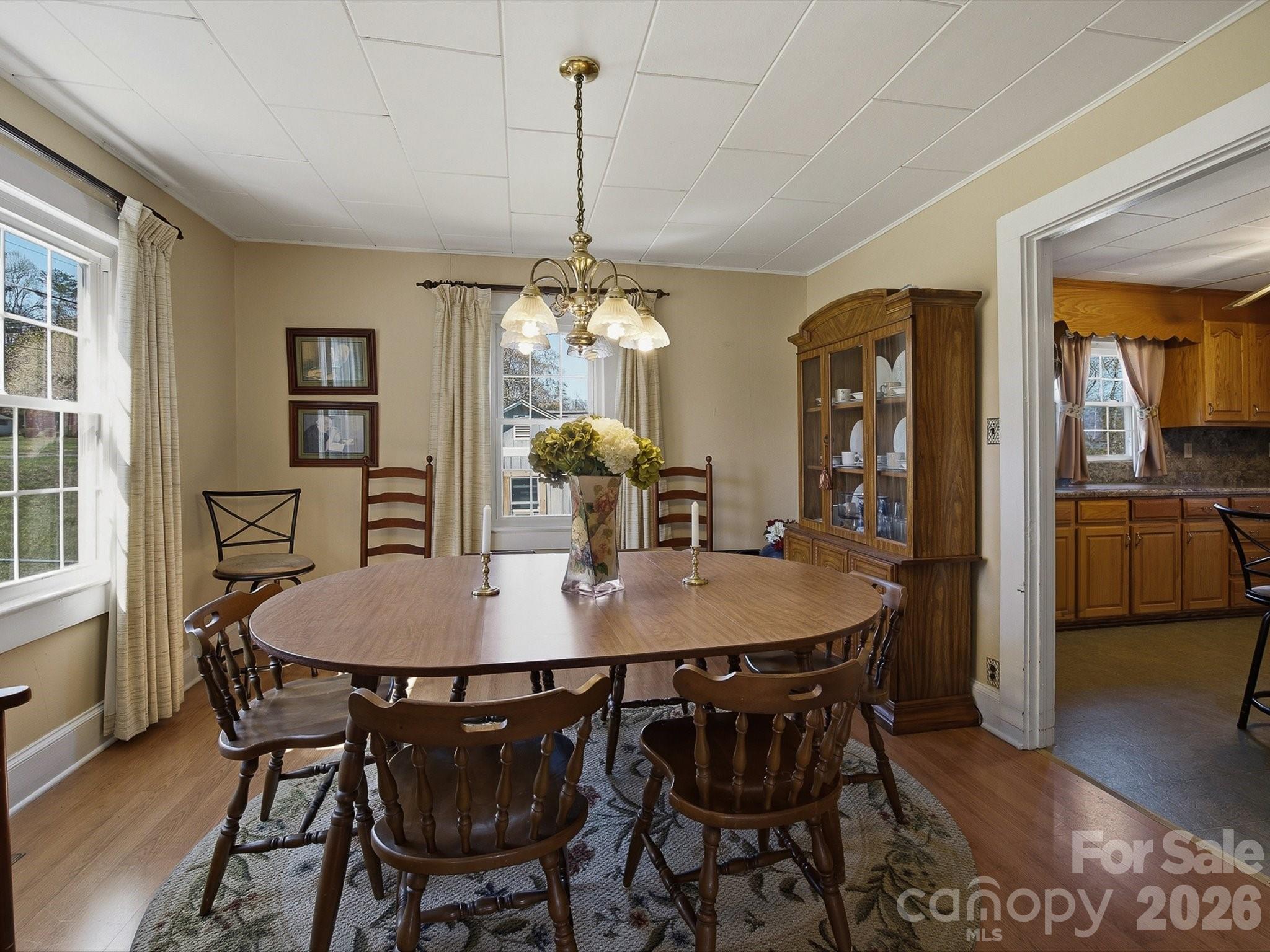 3560 Hartland Road Morganton, NC 28655 - Photo 22 of 27 a dining room with furniture a chandelier and wooden floor