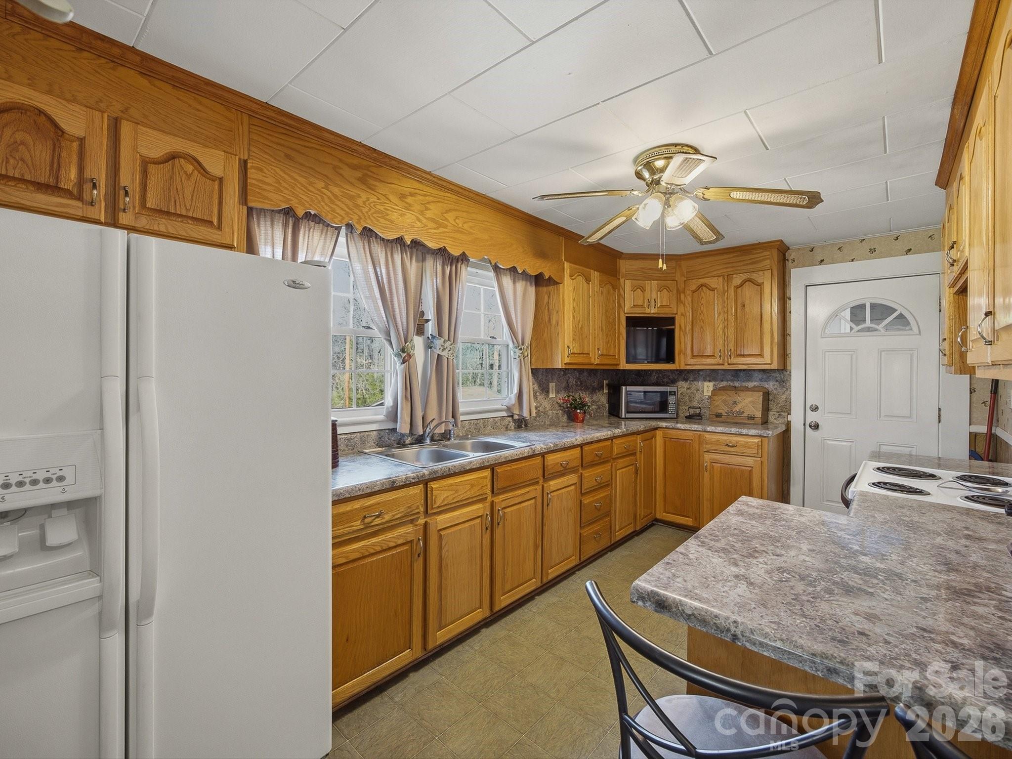 3560 Hartland Road Morganton, NC 28655 - Photo 23 of 27 a kitchen with stainless steel appliances granite countertop a sink refrigerator and cabinets