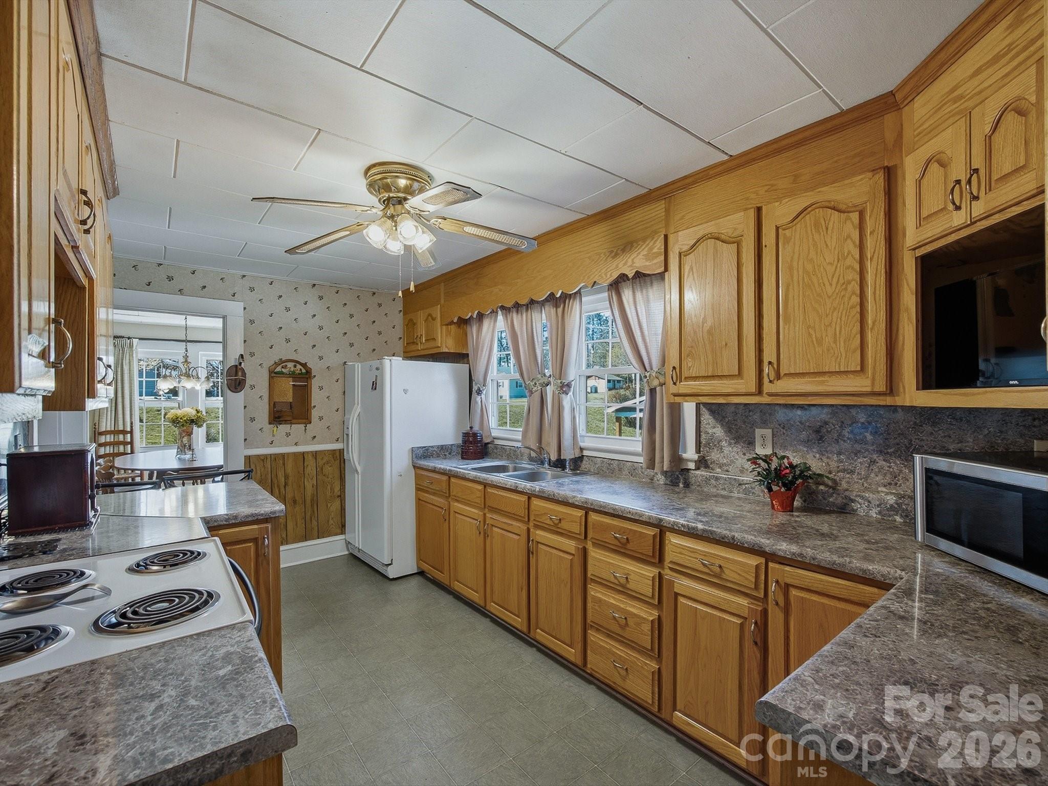 3560 Hartland Road Morganton, NC 28655 - Photo 25 of 27 a kitchen with stainless steel appliances granite countertop a sink stove and cabinets