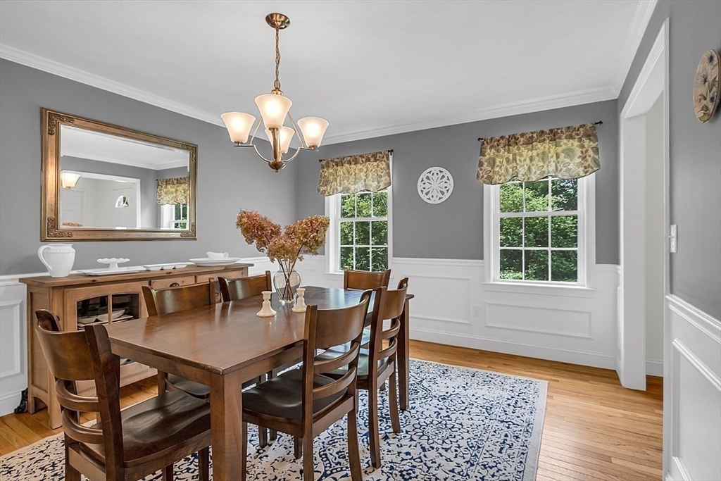 35 Willard Road Westminster, MA 01473 - Photo 11 of 36 a dining room with wooden floor a chandelier a wooden table and chairs