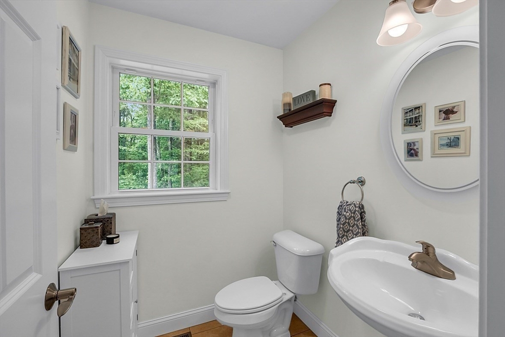 35 Willard Road Westminster, MA 01473 - Photo 15 of 36 a bathroom with a toilet sink a mirror and window