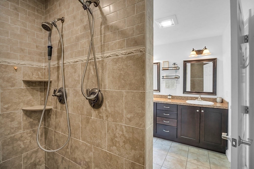 35 Willard Road Westminster, MA 01473 - Photo 20 of 36 a bathroom with a granite countertop shower sink and mirror