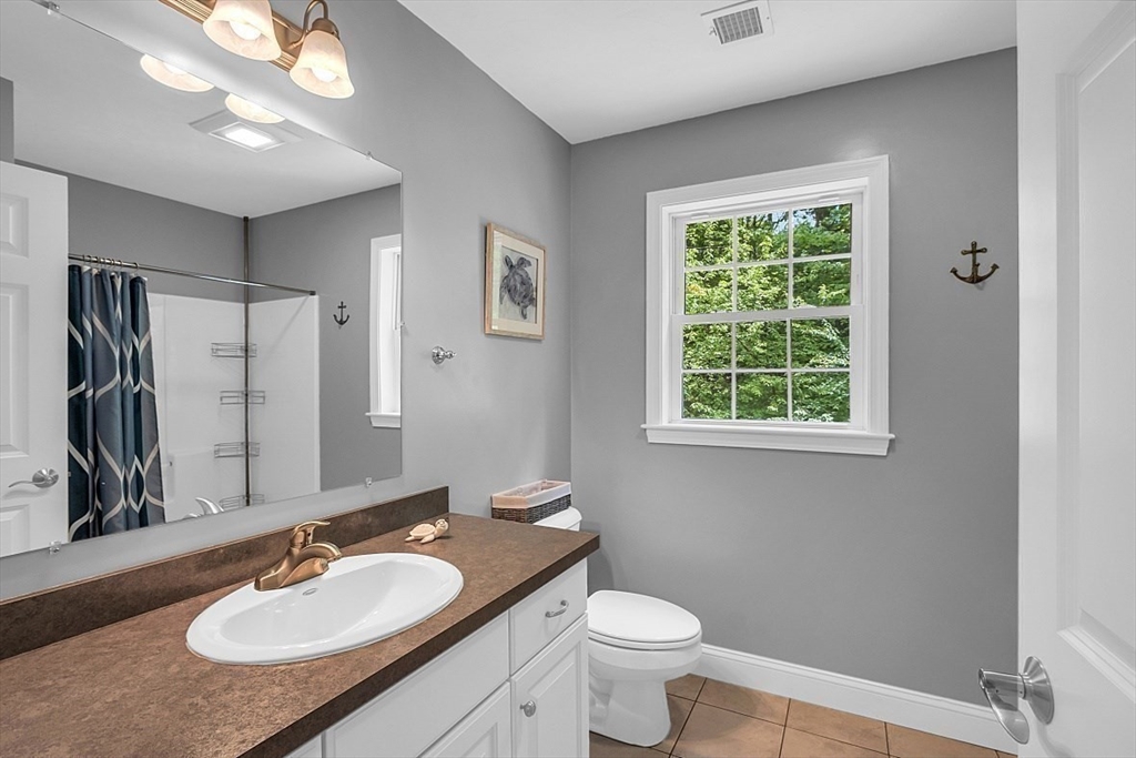 35 Willard Road Westminster, MA 01473 - Photo 23 of 36 a bathroom with a granite countertop sink toilet and a mirror