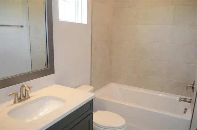 a bathroom with a sink toilet and bathtub
