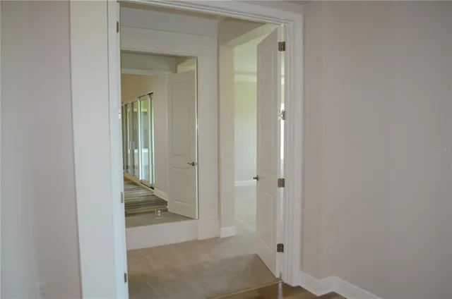 wooden floor with a view of bedroom