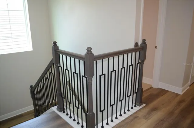 a view of a hallway with wooden floor